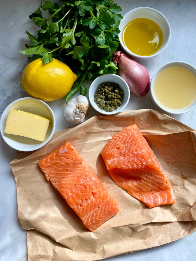 Ingredients for salmon piccata on a marble counter.