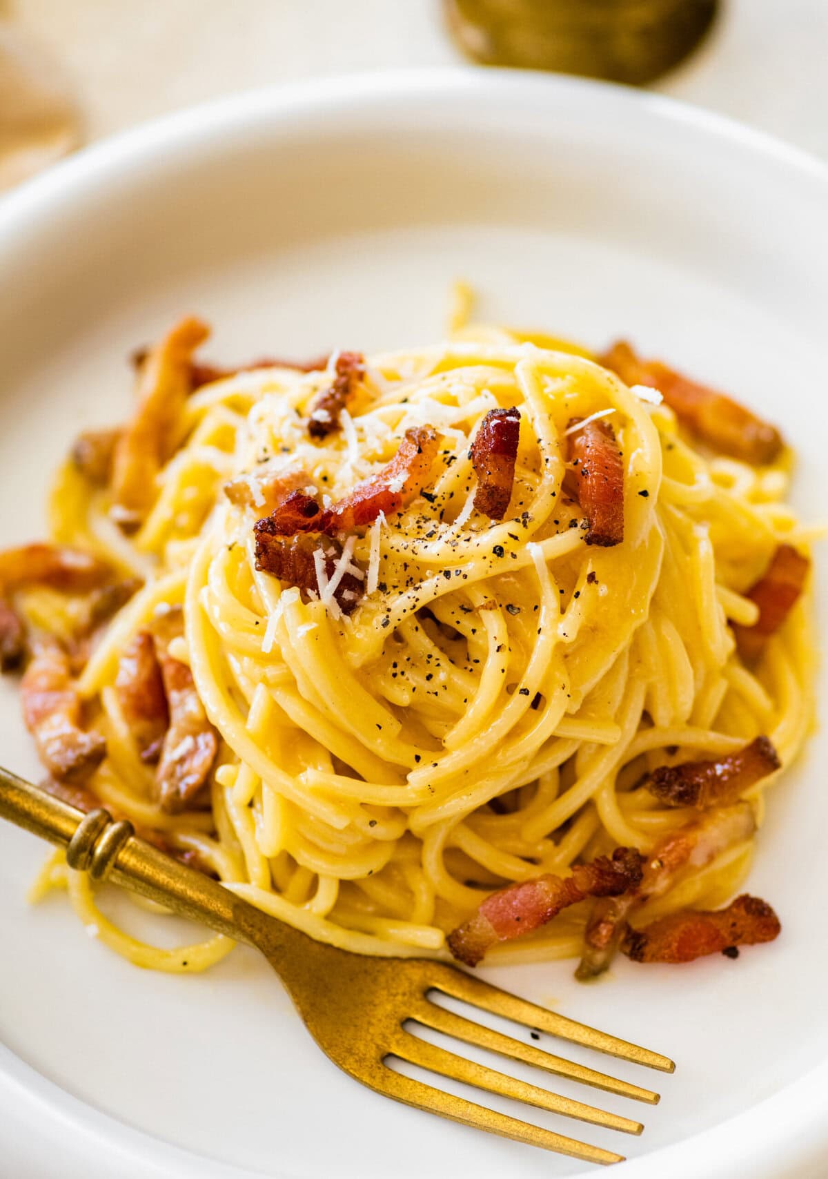 A serving of pasta carbonara on a plate.