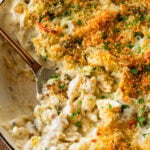 cheese and broccoli pasta bake in a pot, with a fork holding some.