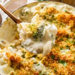 cheese and broccoli pasta bake in a pot, with a fork holding some.