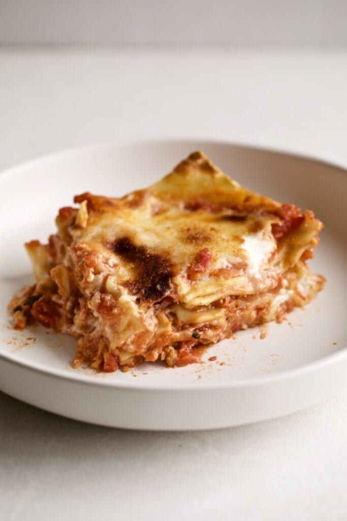 a slice of lasagna on a plate with a fork