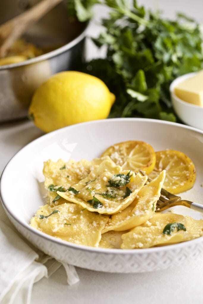 Lobster ravioli in a white bowl.