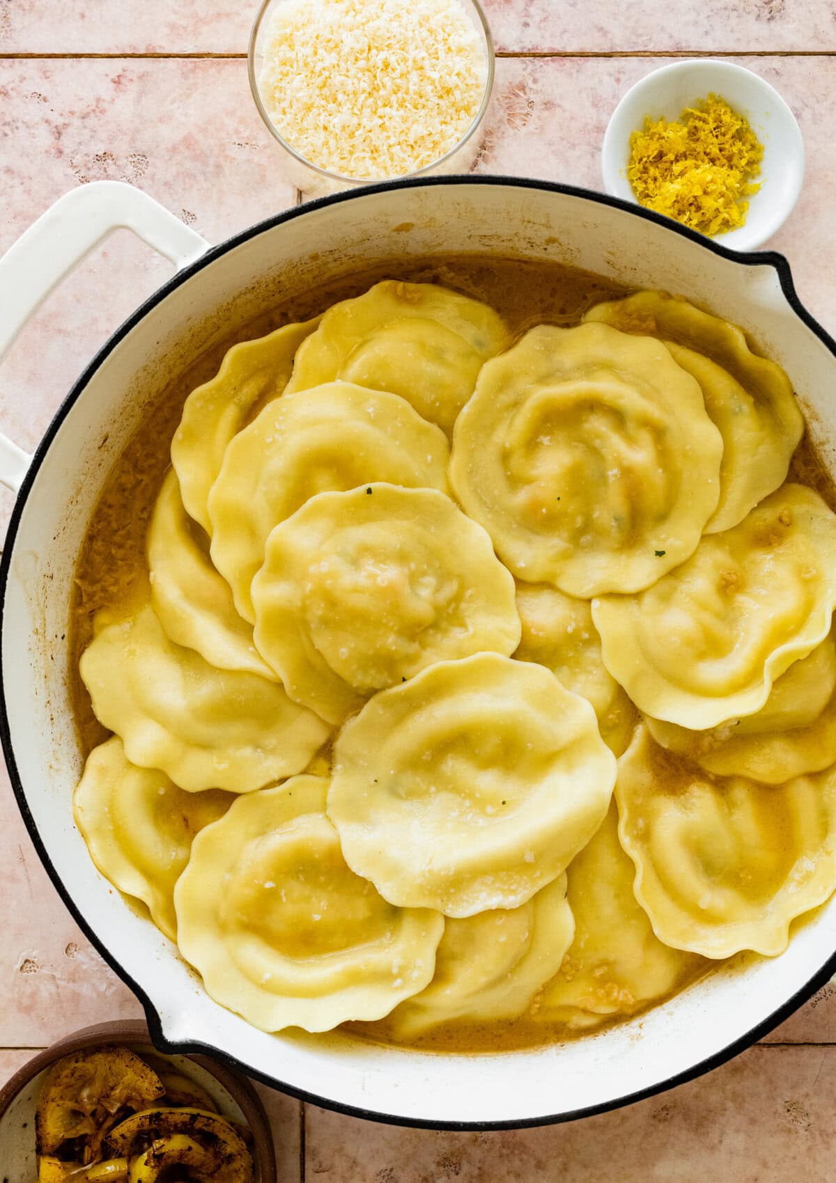 Ravioli added to the skillet.