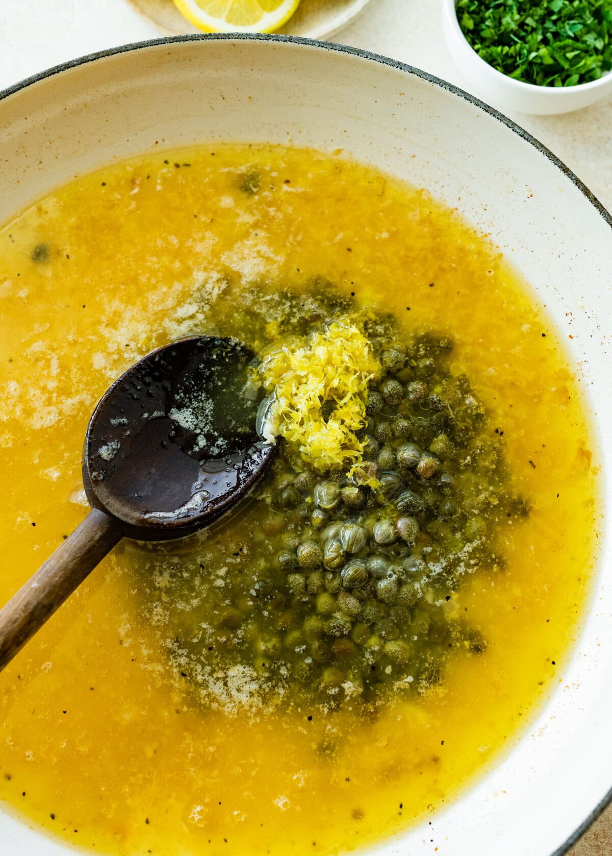 Capers and lemon zest added to the skilet.