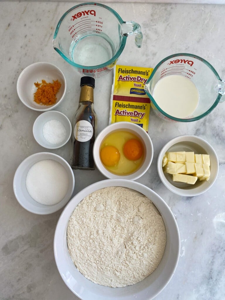 Ingredients for Easter bread on a white counter.