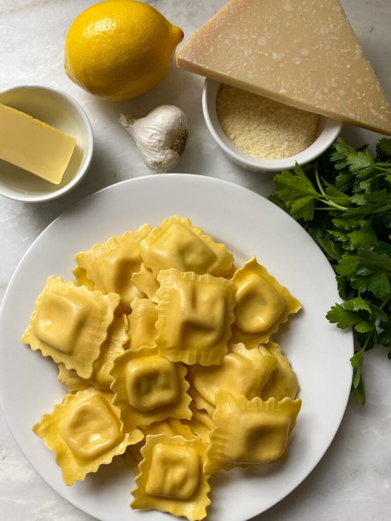 Ingredients for lobster ravioli on a white counter.