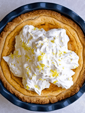 Best Italian Ricotta Pie Recipe (Easter) with whipped cream in a beautiful pie dish