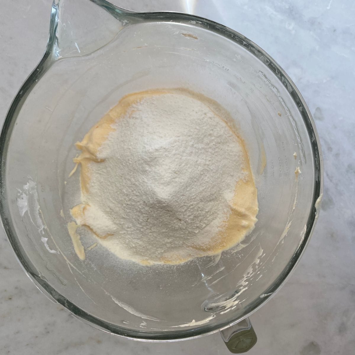 Flour mixture sifted into the eggs.