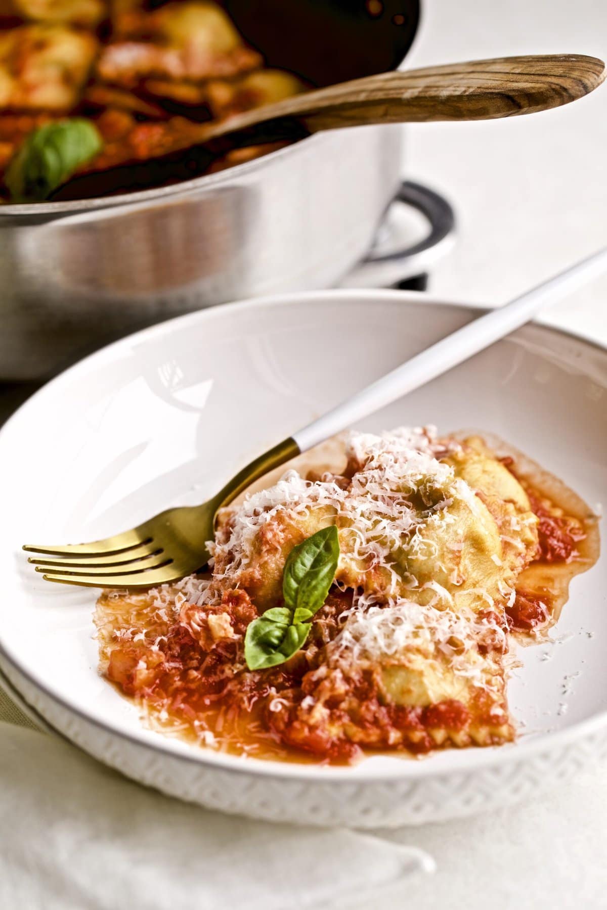 Homemade ravioli in sugo al pomodoro red sauce on a plate with a fork. Ready to eat.