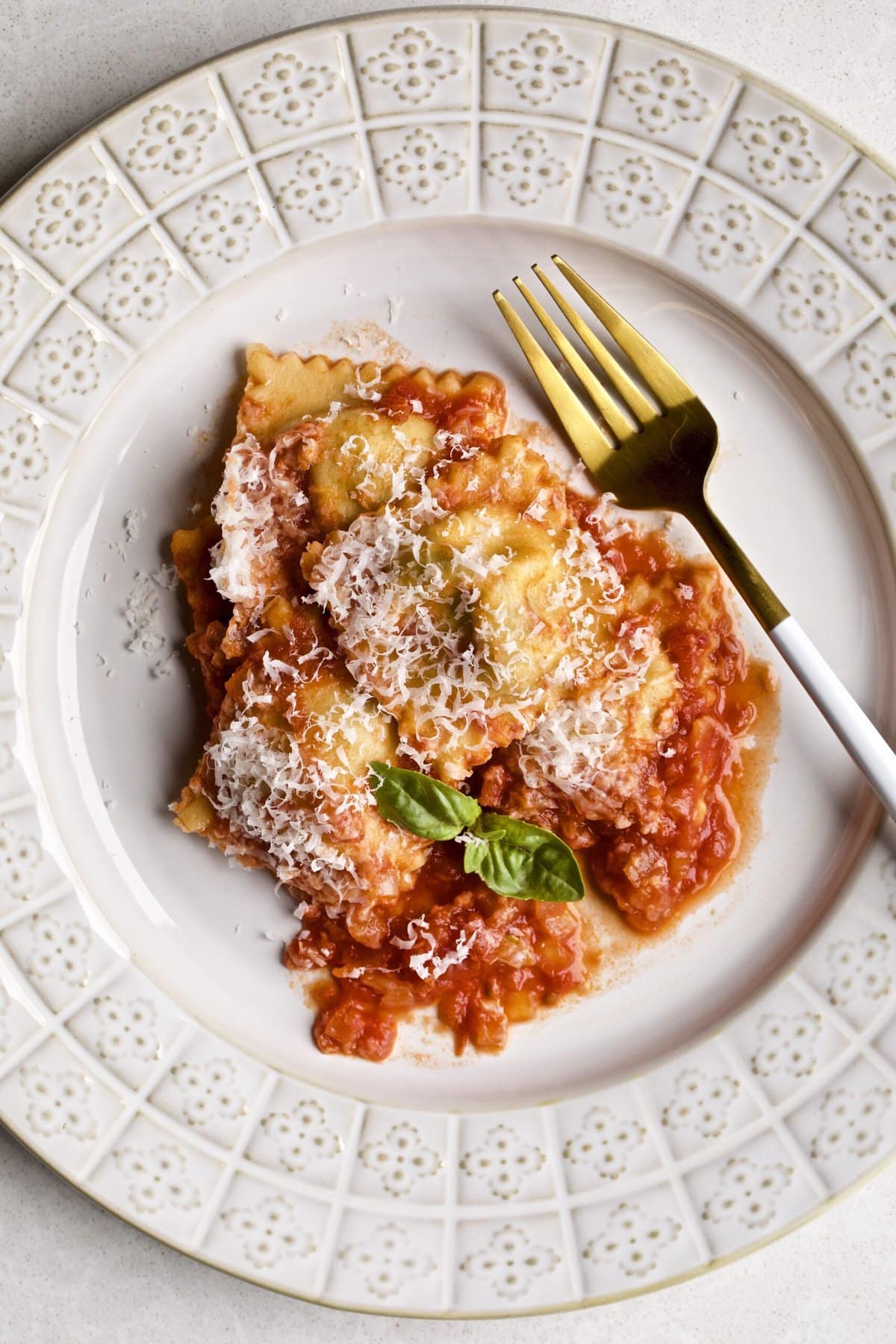 Homemade ravioli in sugo al pomodoro red sauce on a plate with a fork. Ready to eat.