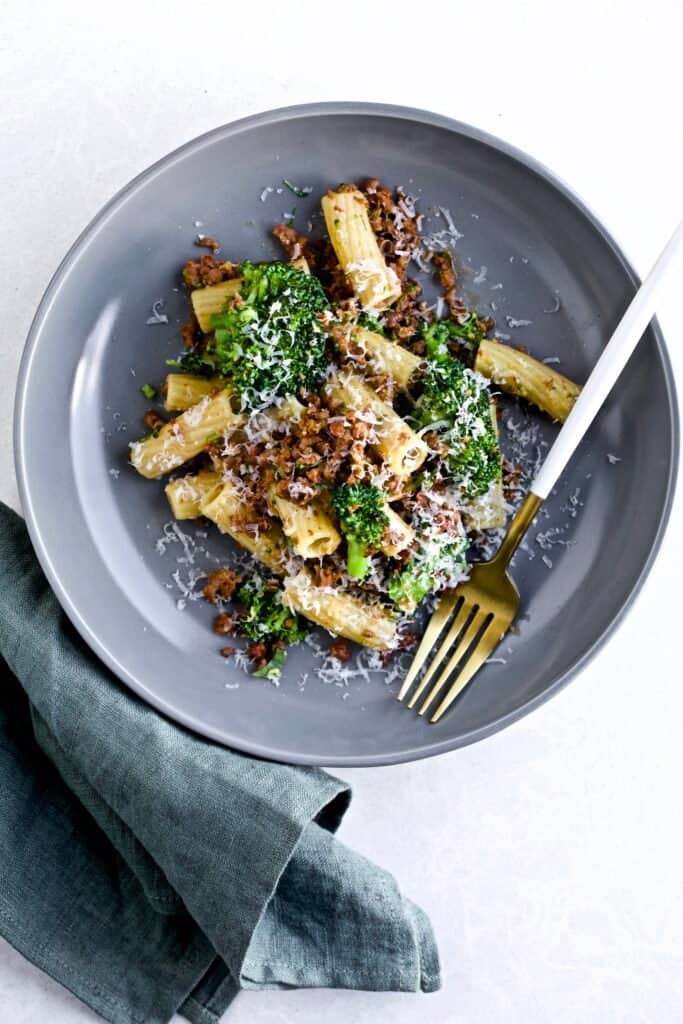 Broccoli Pasta with Sausage Recipe (Italian)- on a plate with a fork and a green napkin.