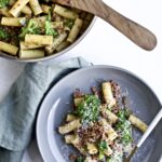 Broccoli Pasta with Sausage Recipe (Italian)- on a plate with a fork. Pan in the background.