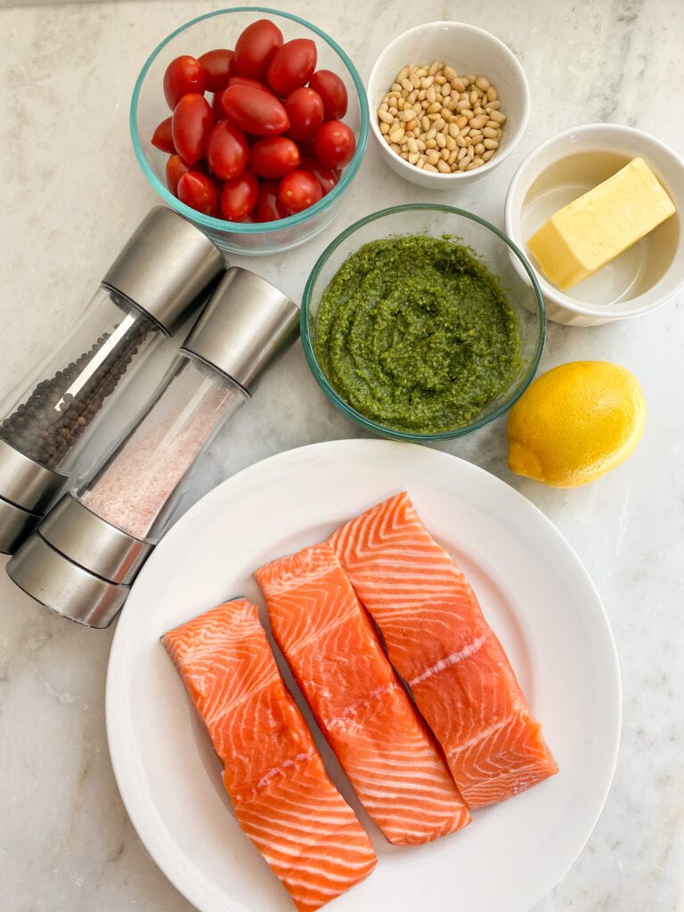 Ingredients for salmon pesto on a marble countertop.