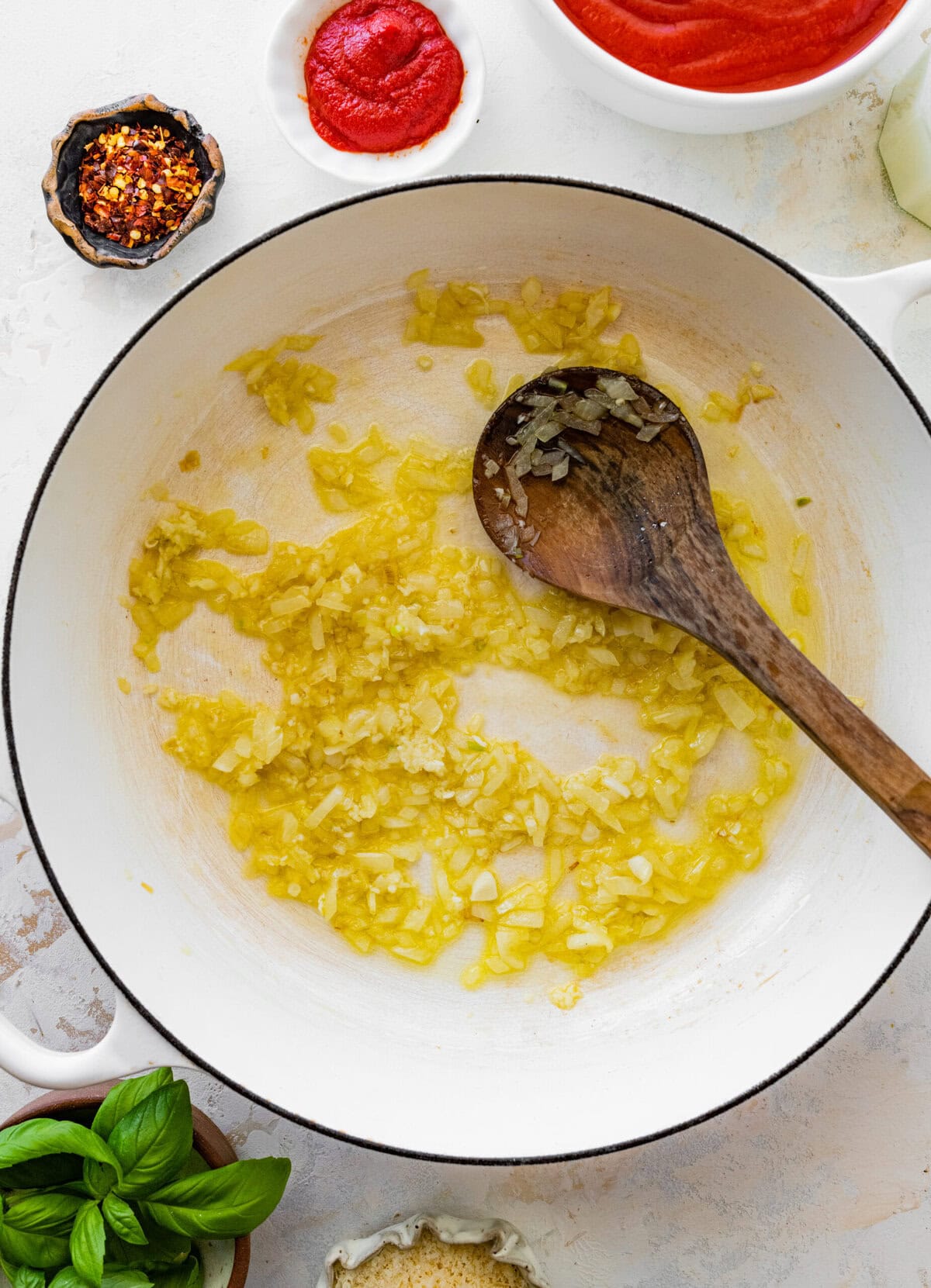 onions in pan with wooden spoon- cooking.