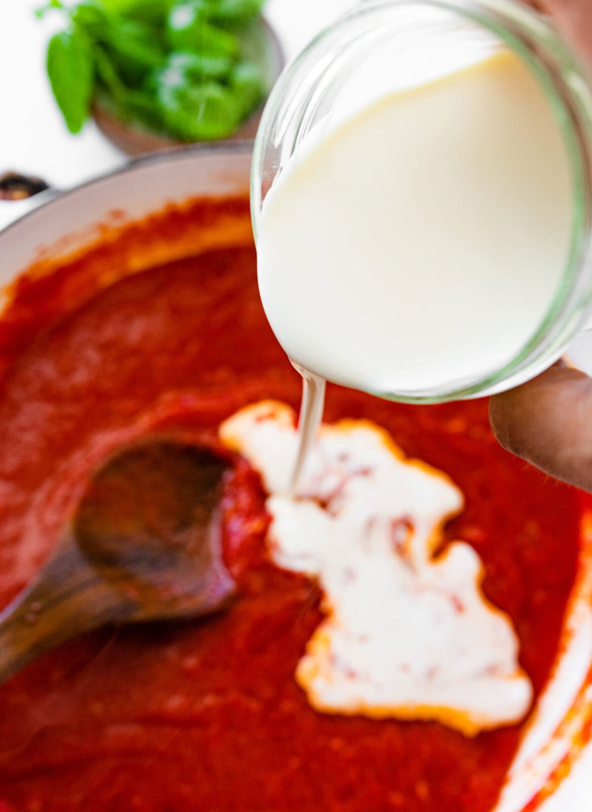 pour cream into a pan with the sauce.
