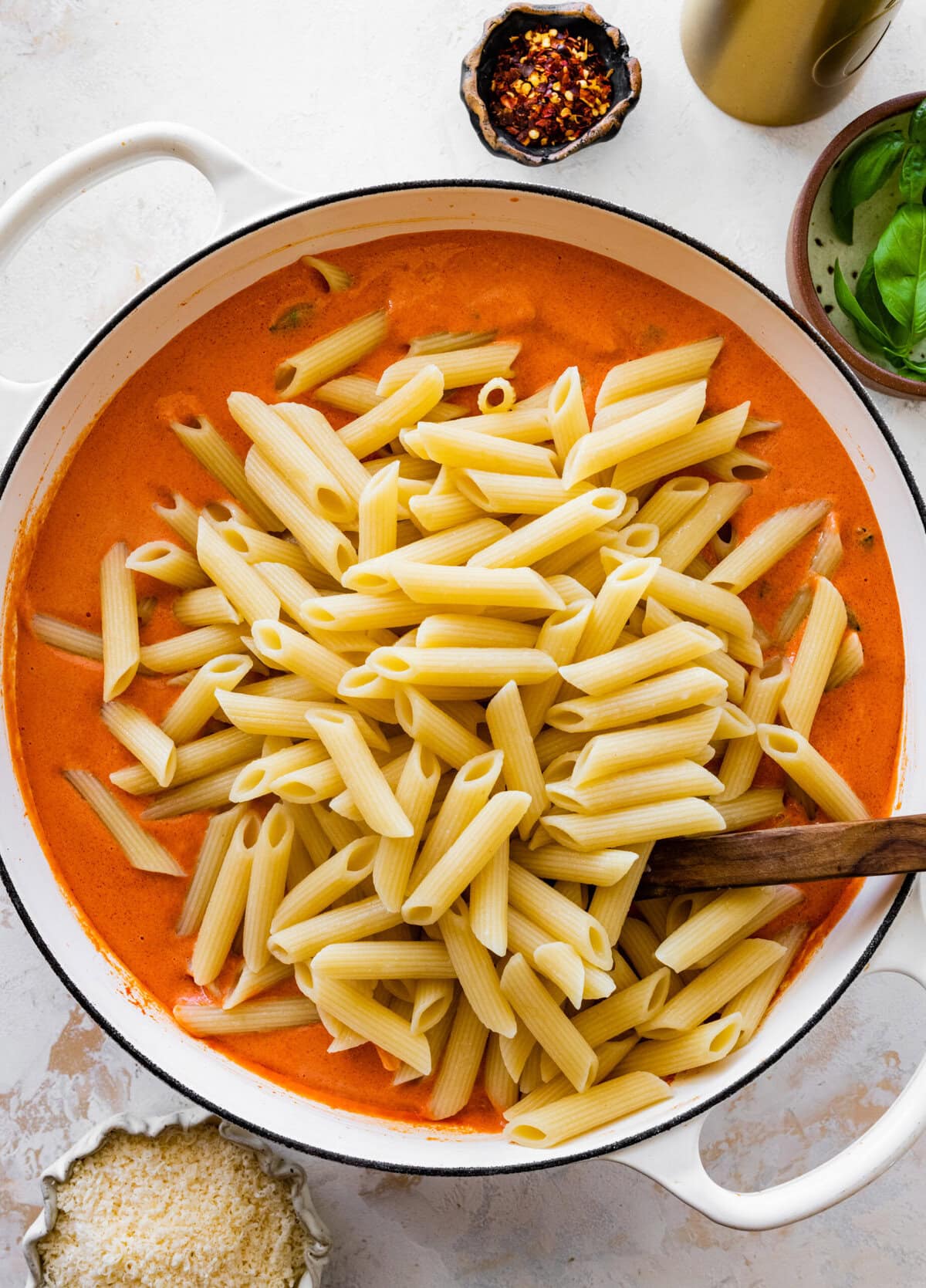 Add al dente penne pasta in pan with the sauce.