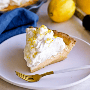 A slice of ricotta pie on a dish with a fork.