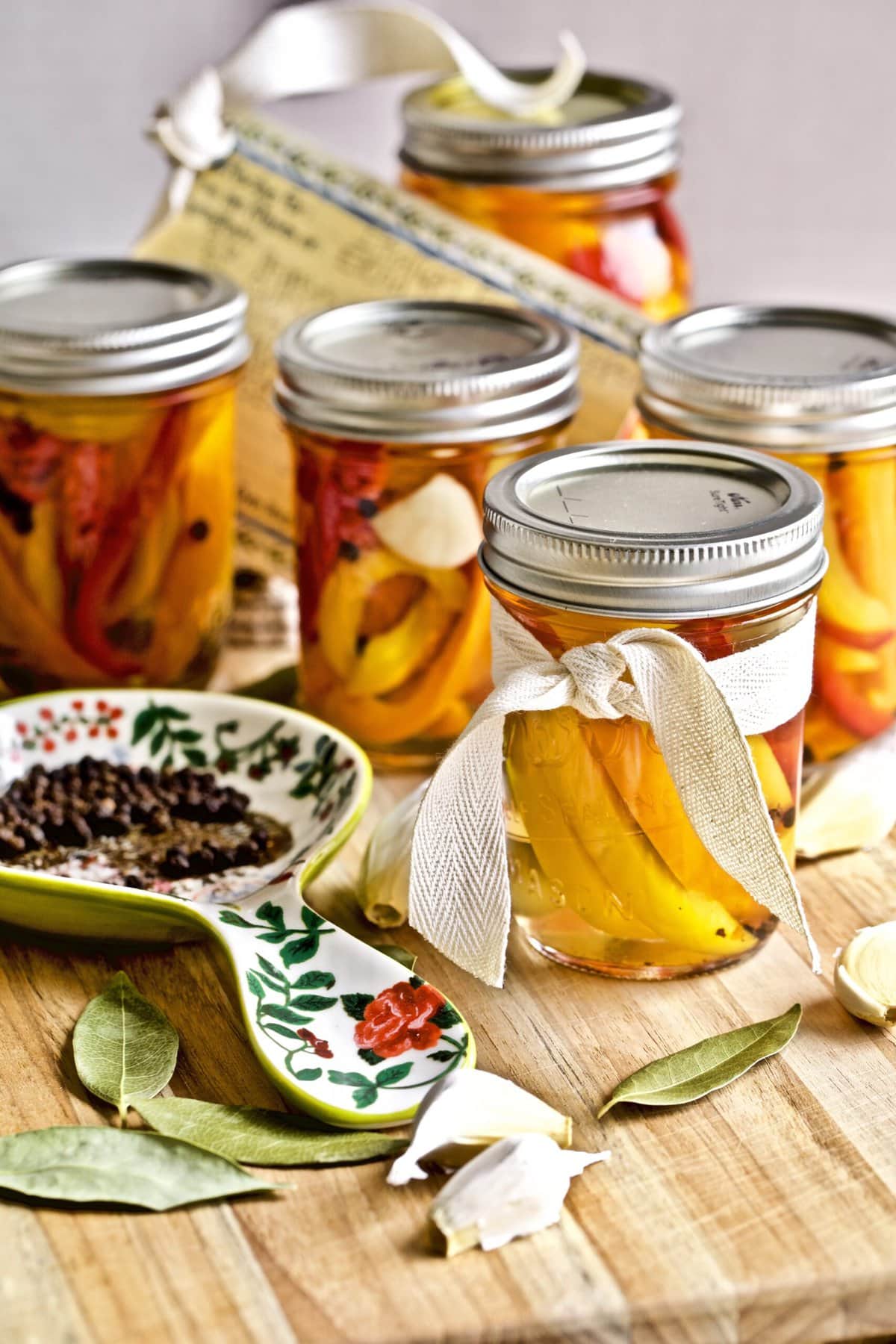 Italian vinegar peppers in a jars with ingredients and handwritten recipe card. 