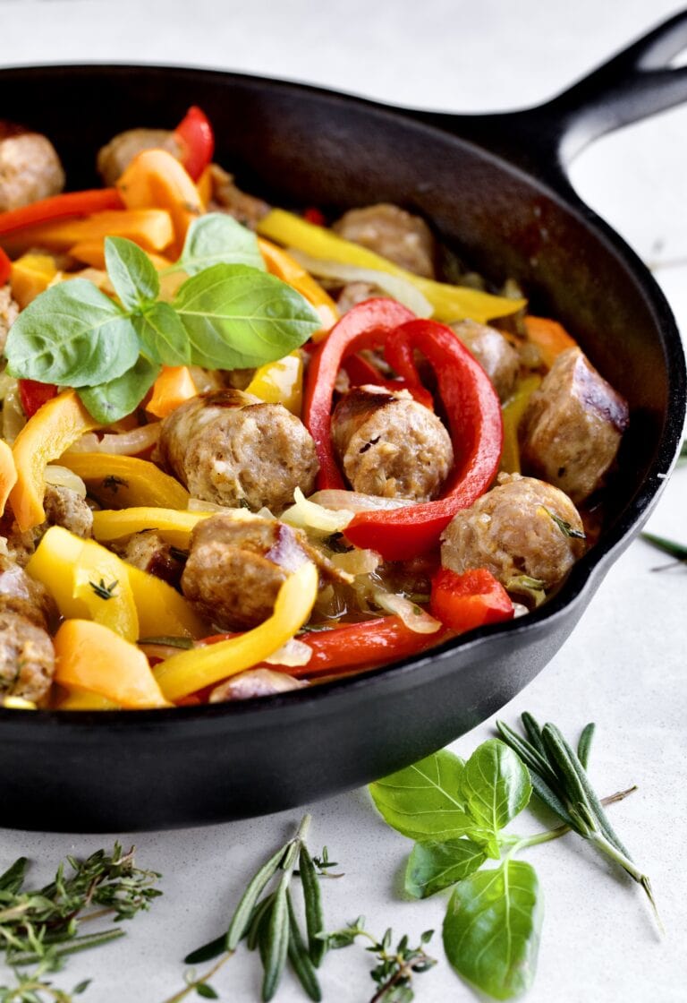 sausage and colorful peppers in a skillet