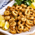 Crispy Calamari Air Fryer Recipe on a plate with lemons.
