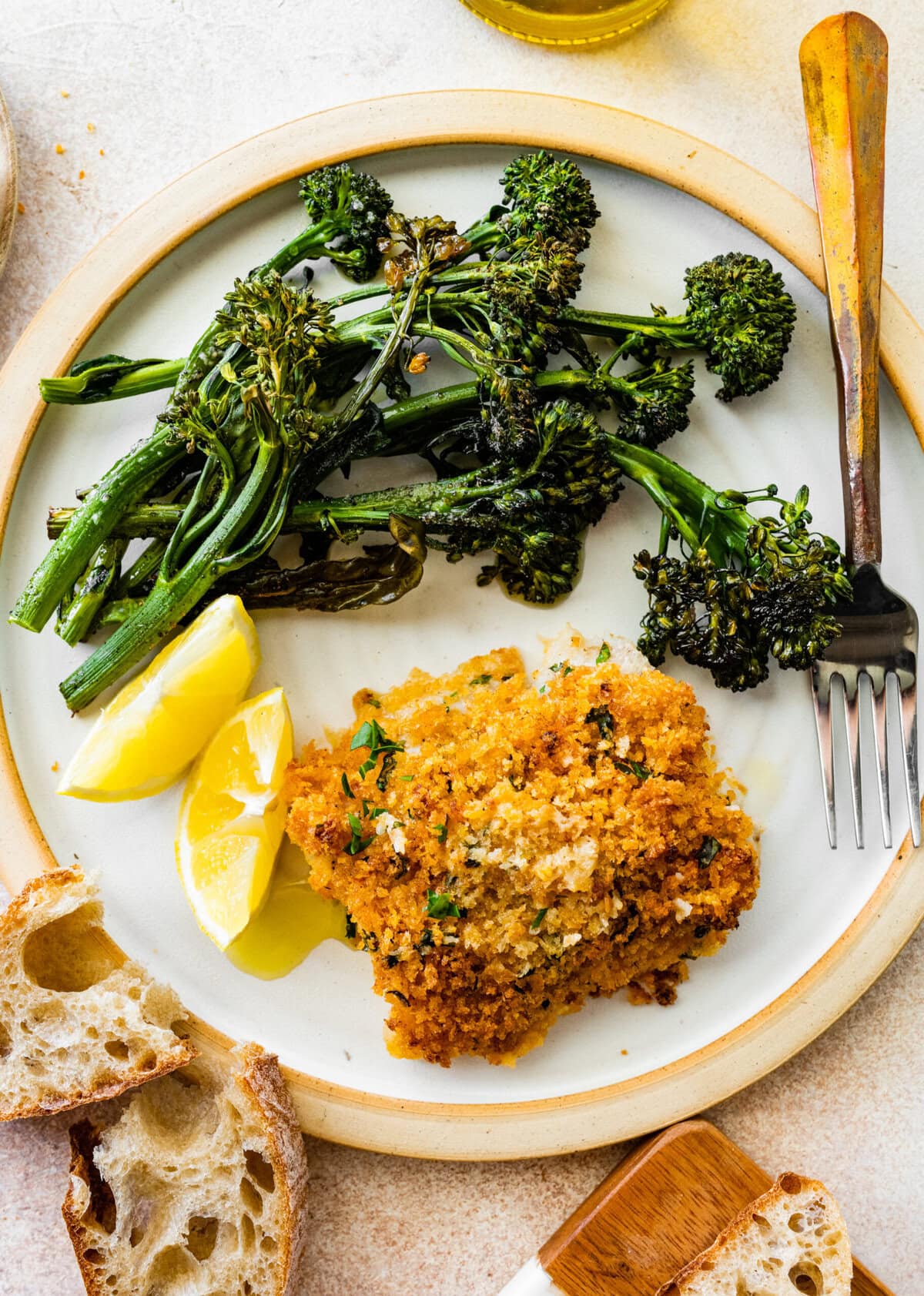 crispy baked cod with panko on a plate with broccolini.