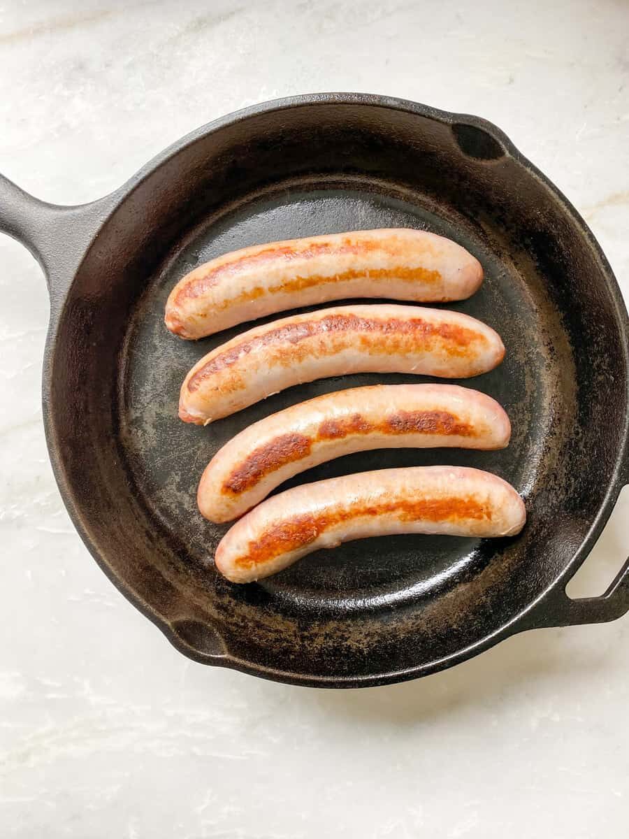 process: grilling the sausages on the cast iron pan.