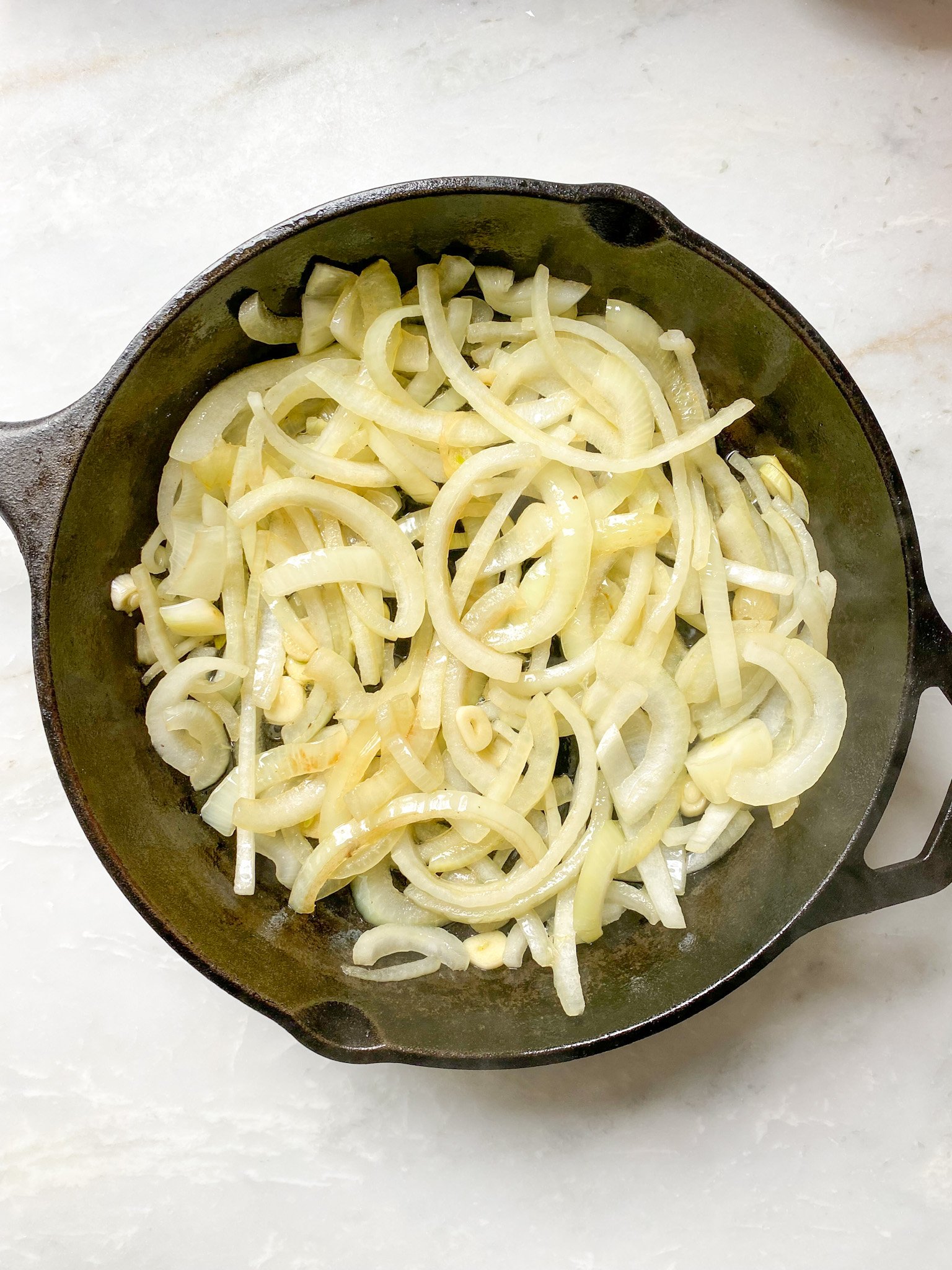 process: grilling the onions and garlic on the cast iron pan.