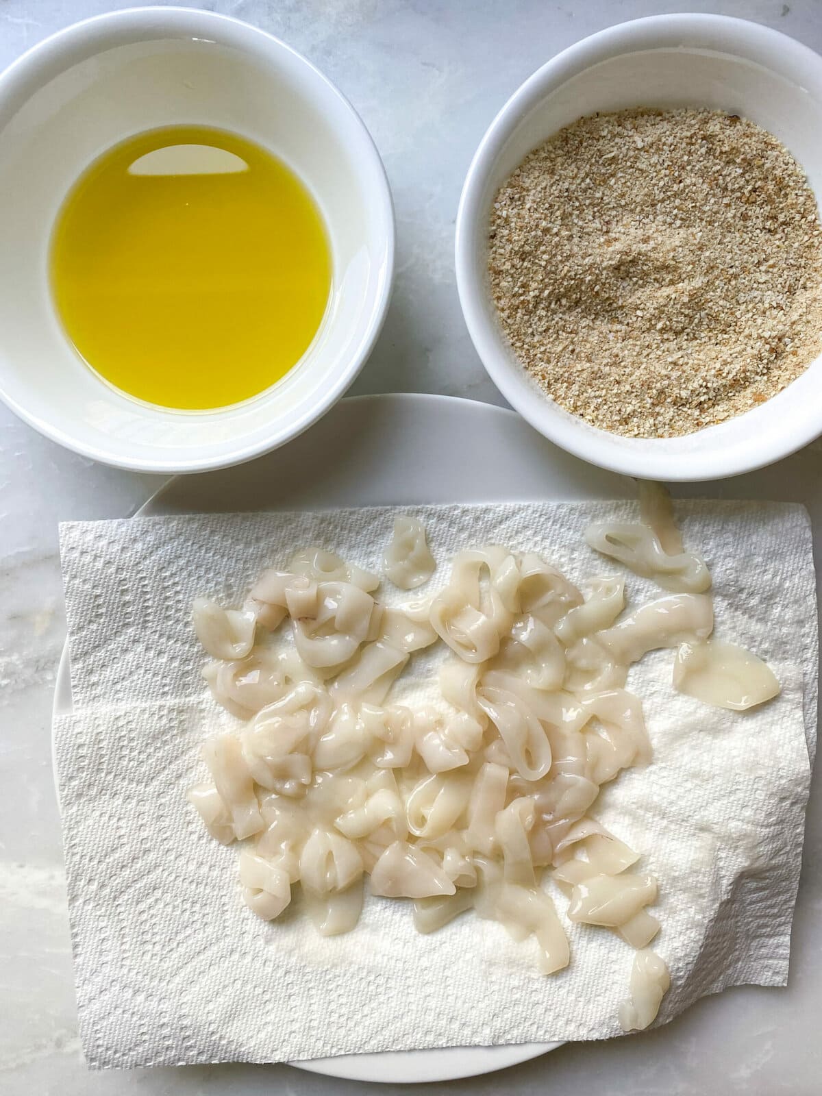 dipping the calamari in bread crumb mixture 