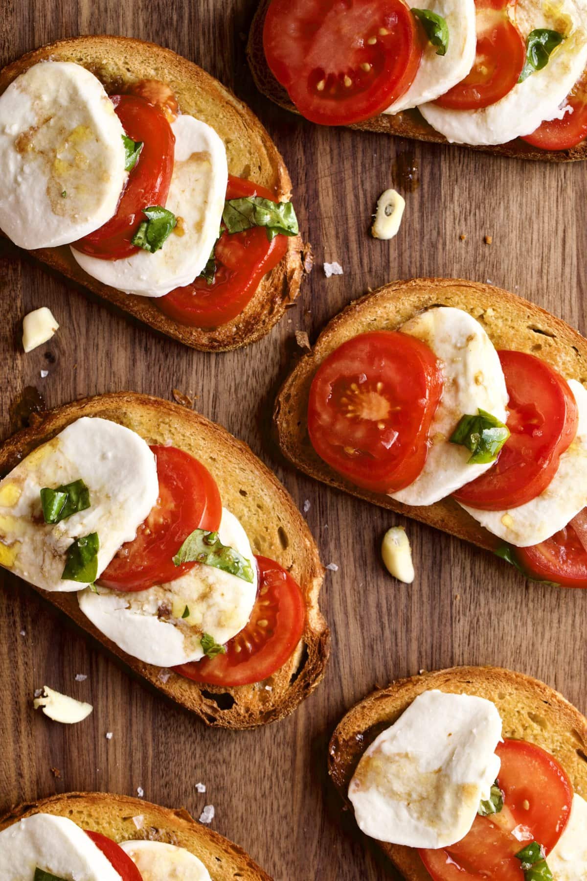 platter of bruschetta with tomatoes and mozzarella basil .