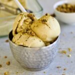 Italian pistachio gelato in a cup with a spoon.