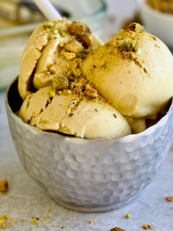 pistachio ice cream in metal bowl with spoon.