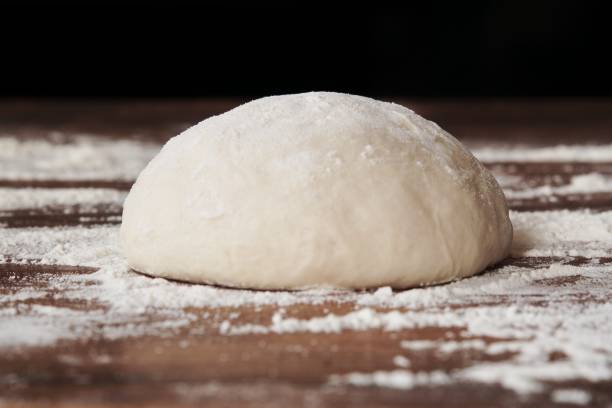Ball of dough on a floured board.