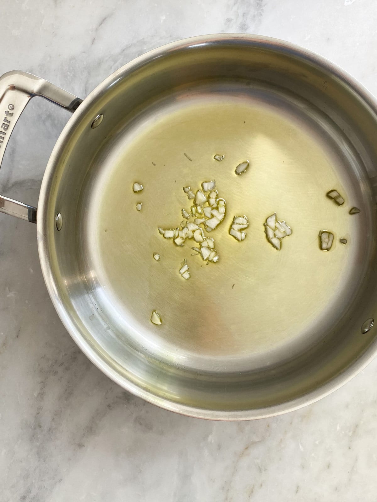 process- sautéing garlic in olive oil