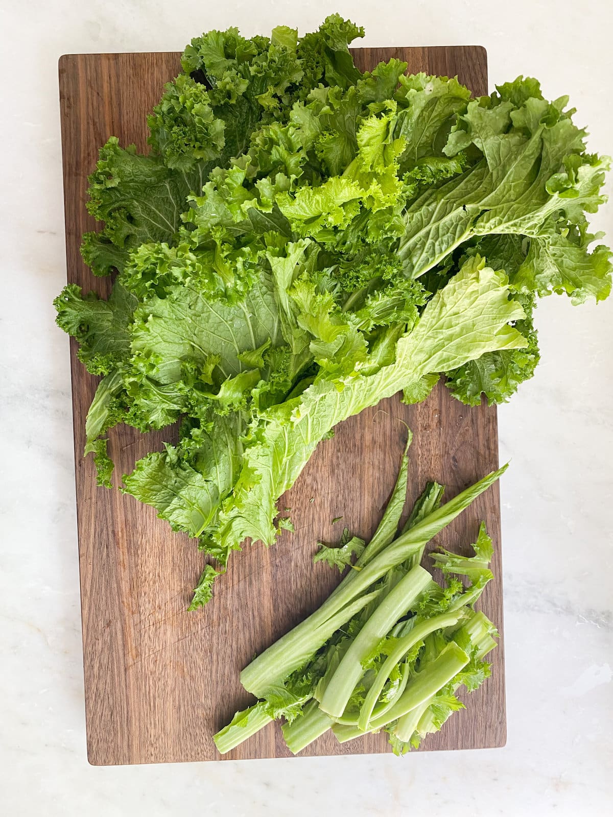 preparing the escarole by cutting off steams. 