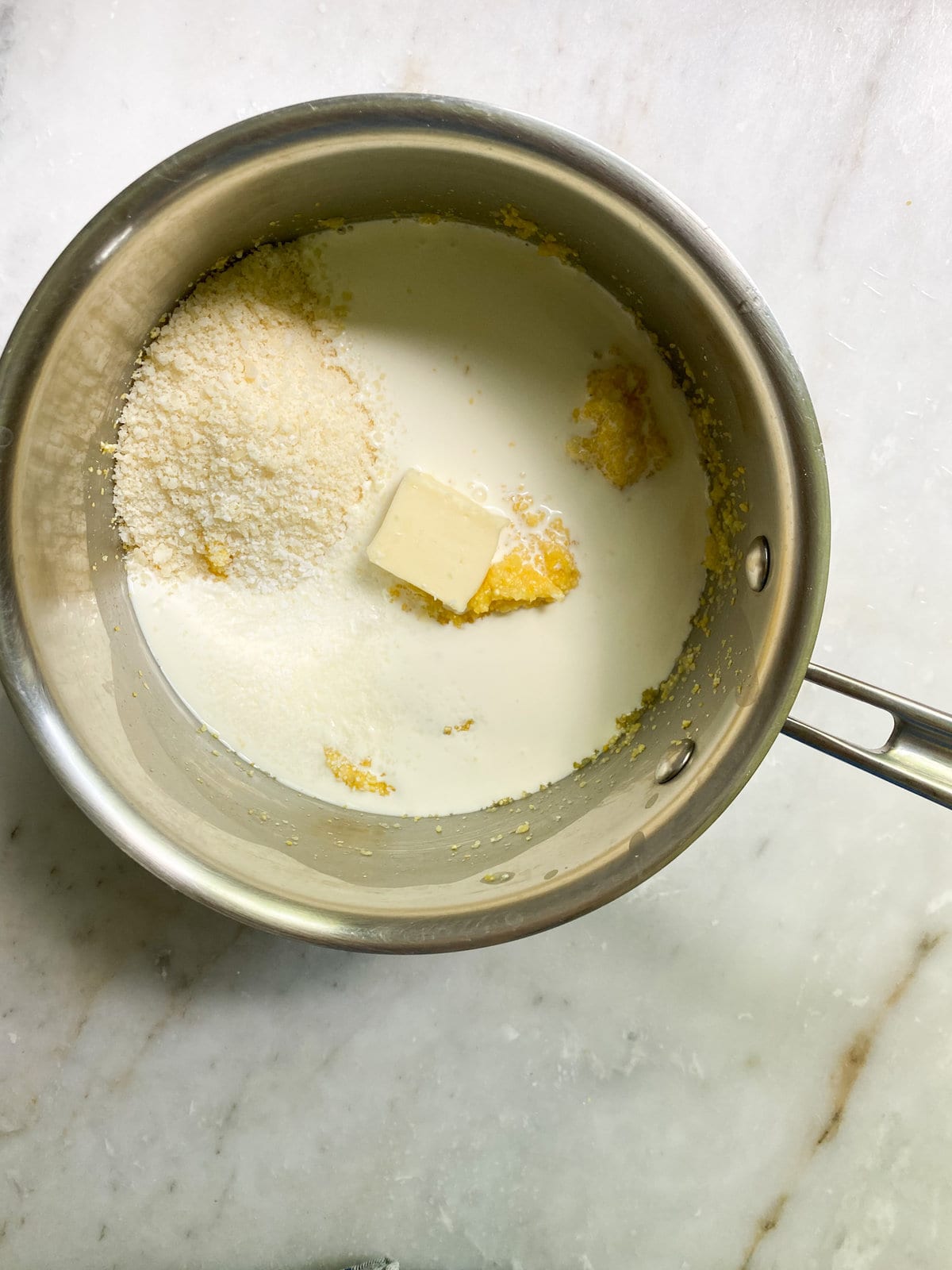 adding cheese, cream, and butter to polenta