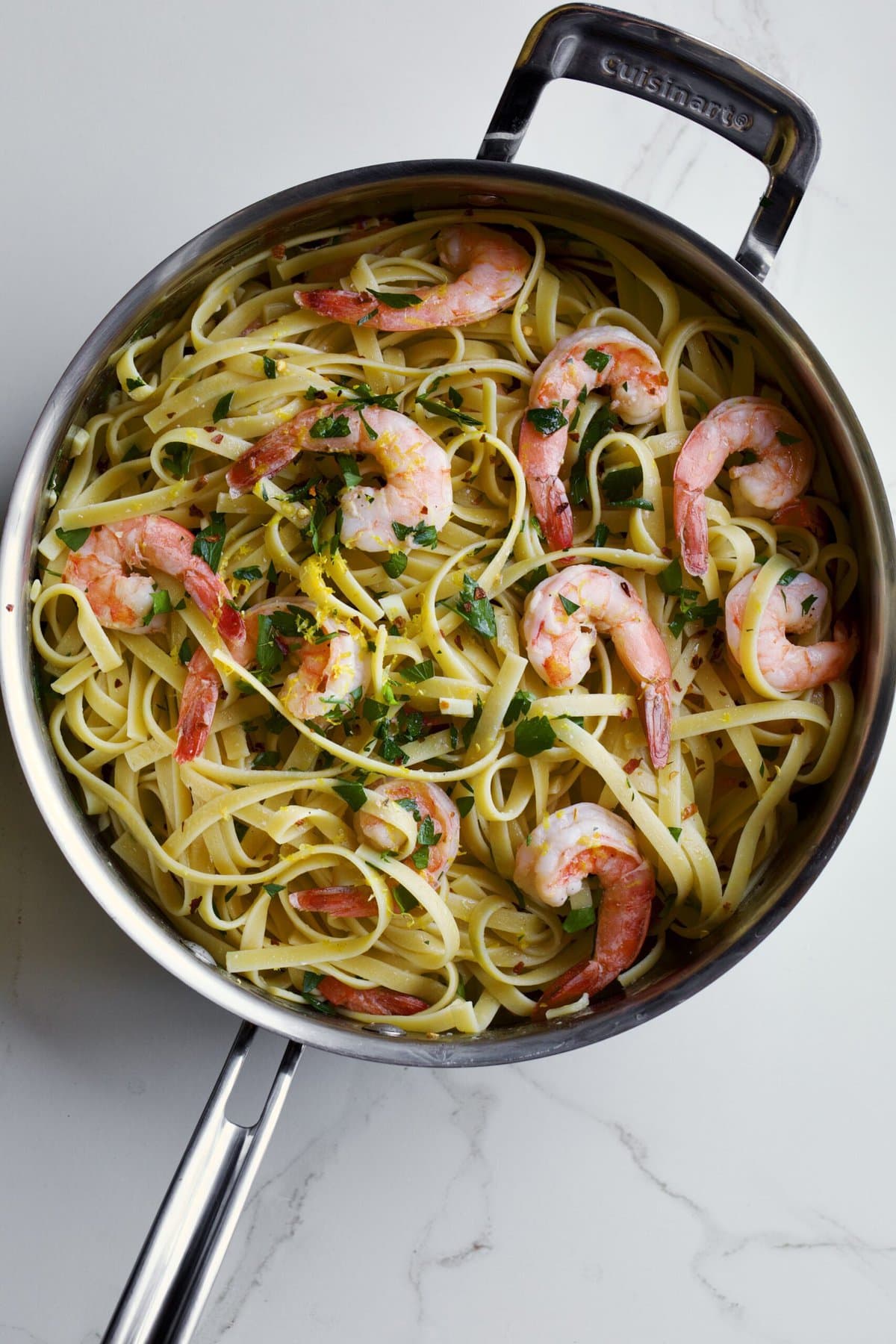 Shrimp scampi fettuccine in a pan ready to serve.