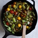 Italian green beans and tomatoes cooked in cast iron pan