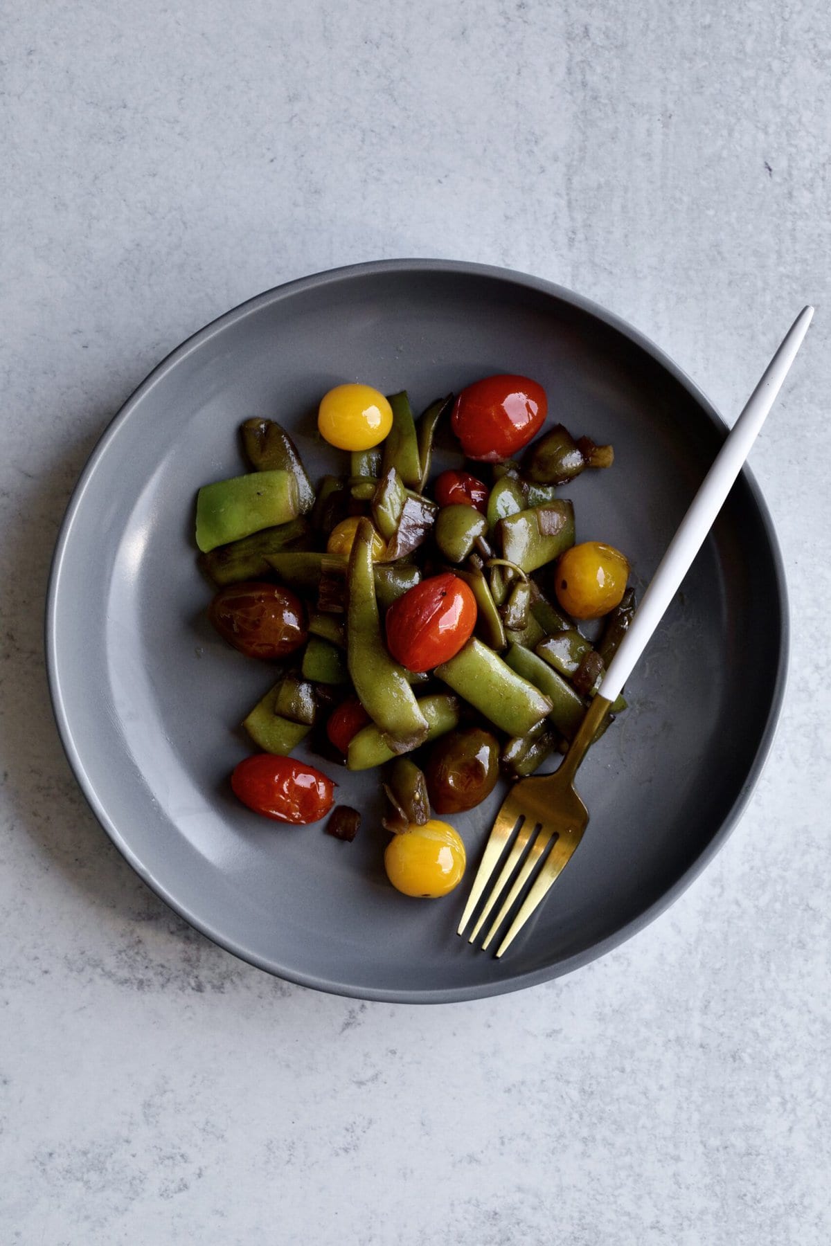 Italian flat green beans on a plate with a fork 