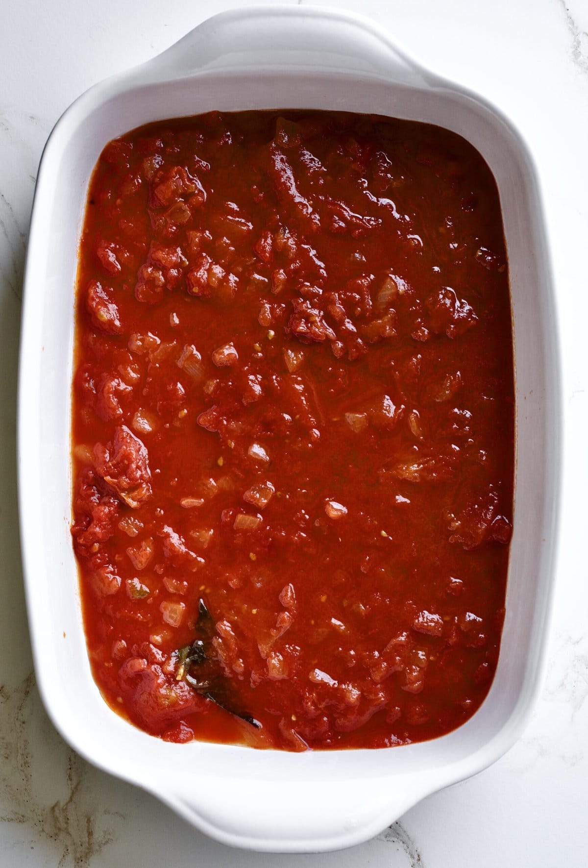 homemade tomato sauce at the bottom on the serving dish.