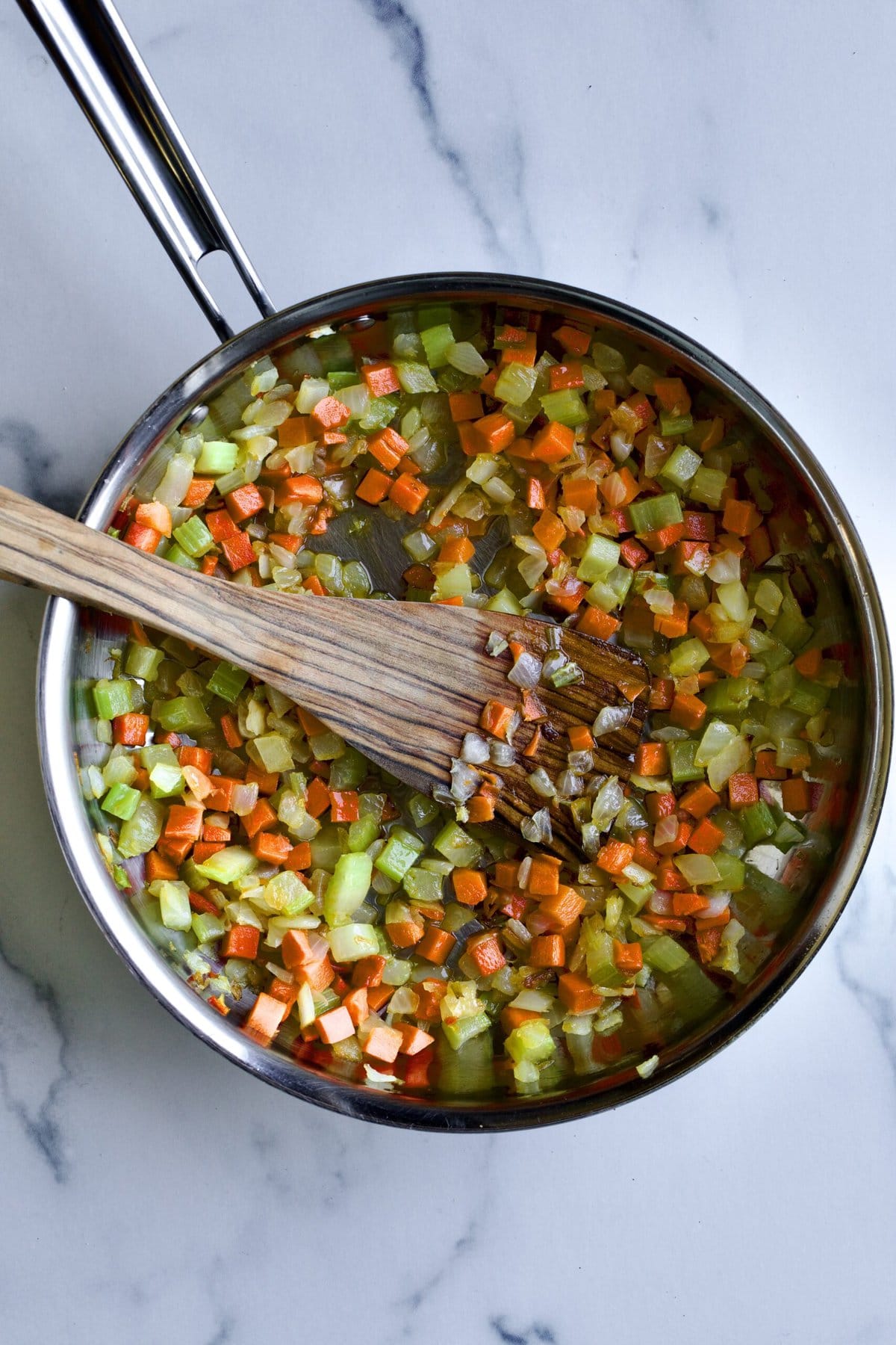 finished soffritto in a pan with wooden spoon. 