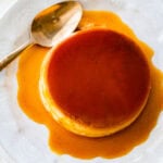 close up of creme caramel on a white plate with a spoon.