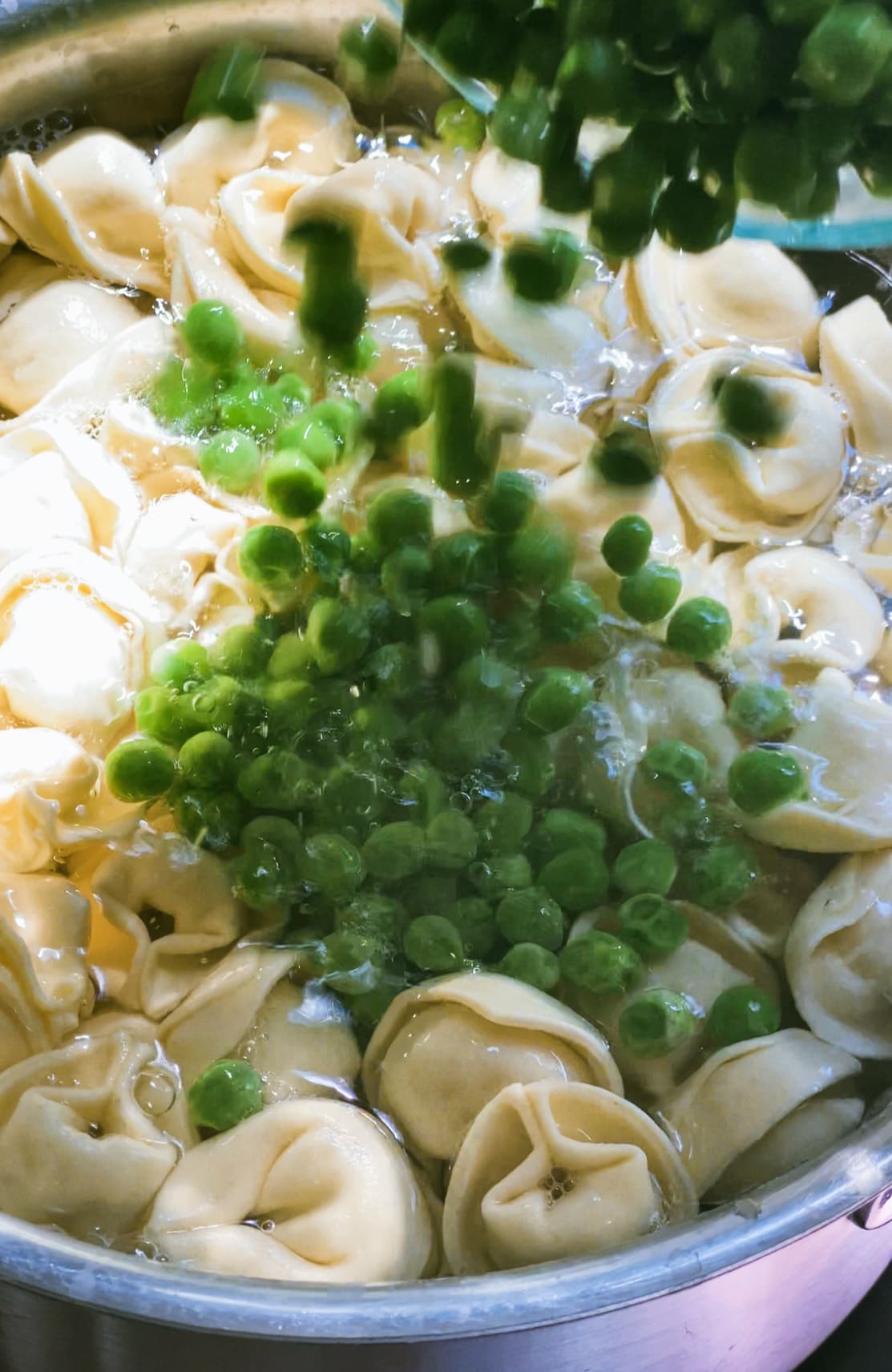 cooking tortellini and peas process photo. 