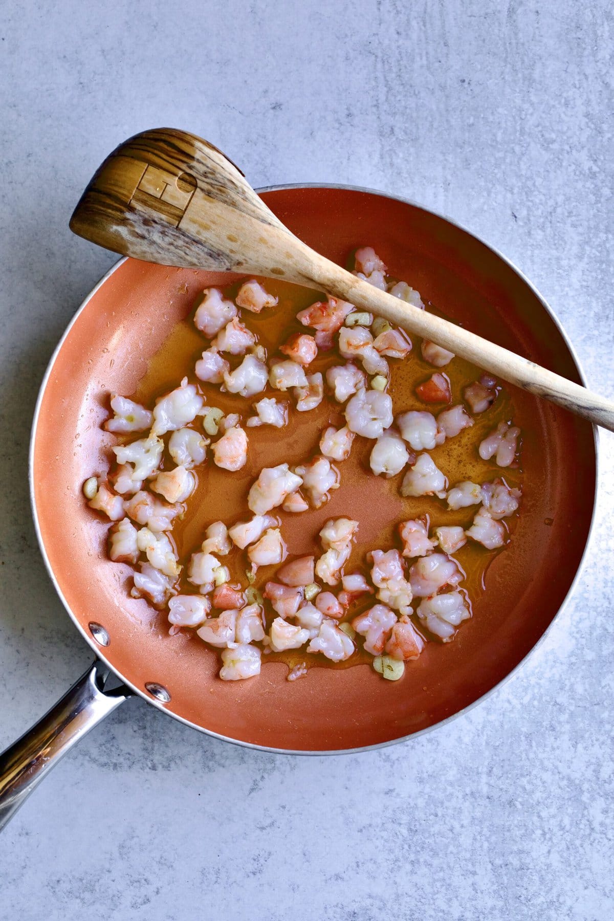 shrimp sautéing in pan with garlic.