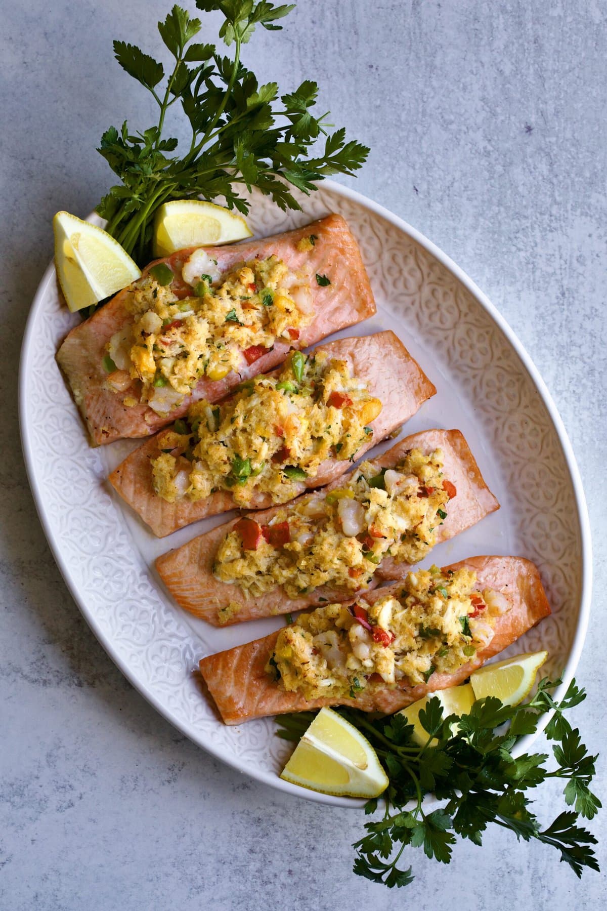 large serving platter with fillets of stuffed fish. Garnish lemon wedges and parsley.