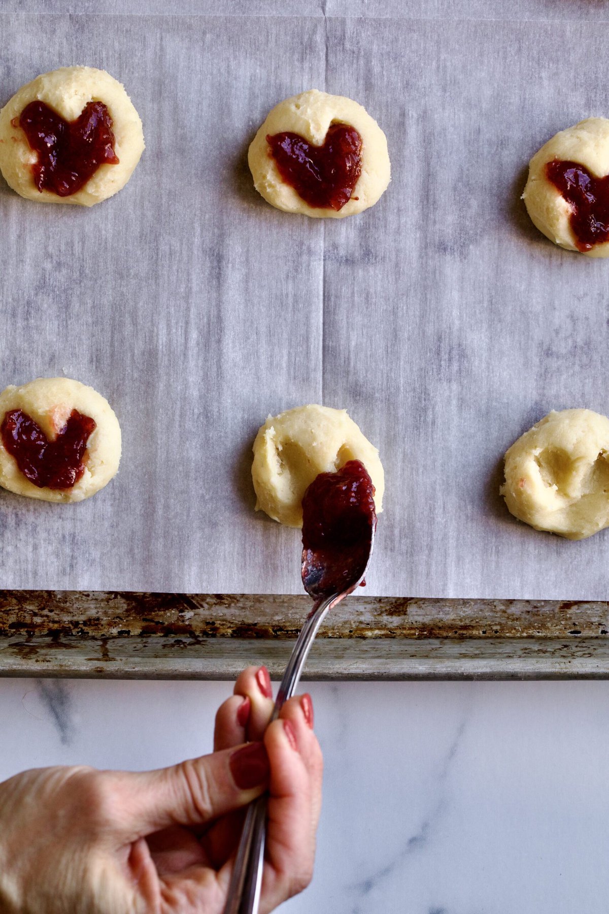 filling cookies with jam before baking them.