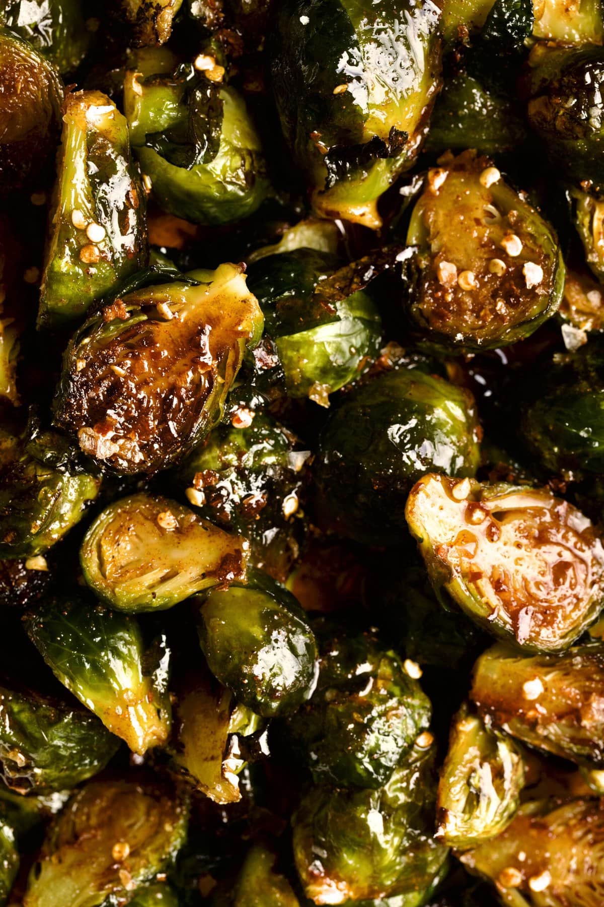 up close photo of crispy Brussels sprouts with sauce.
