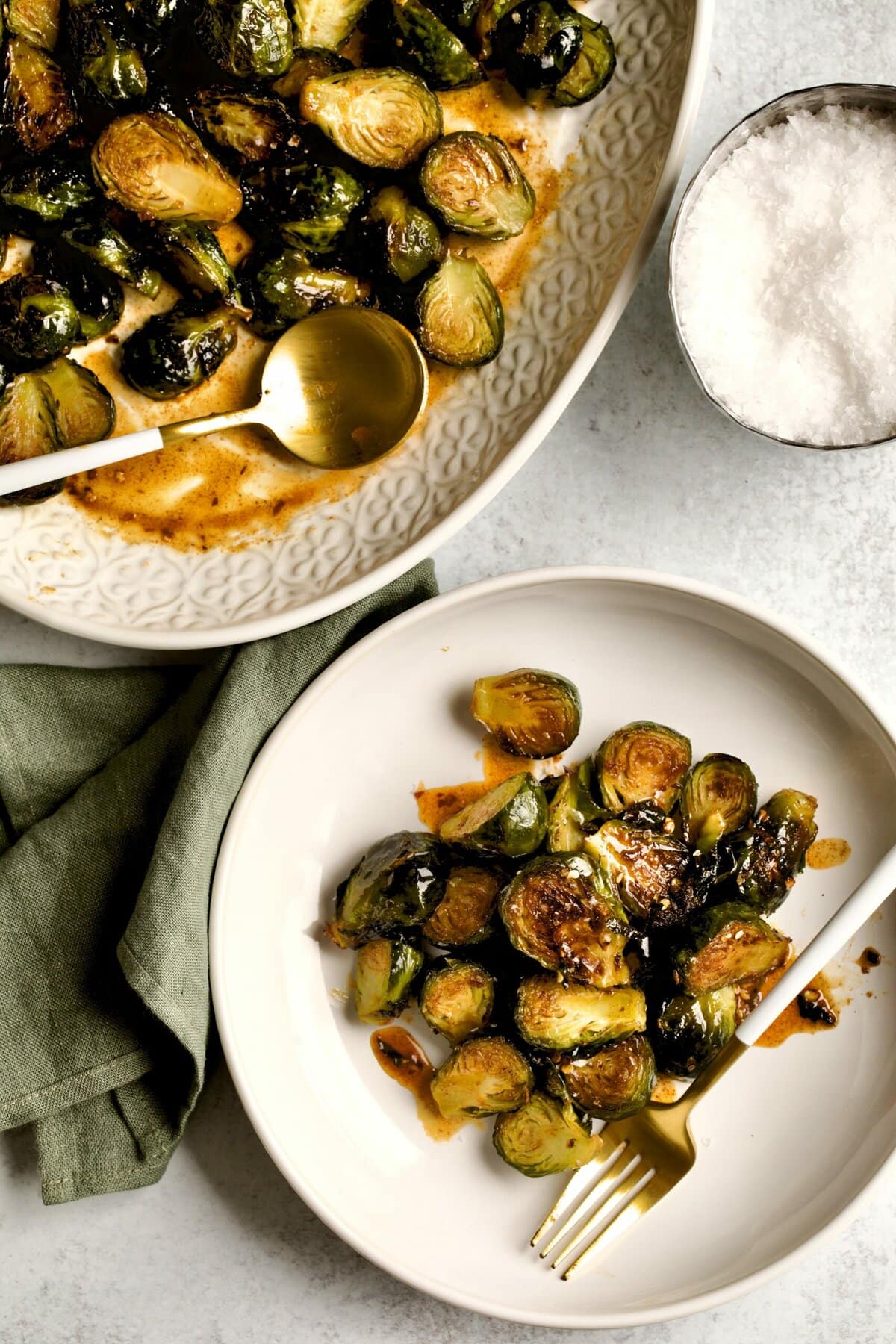 Copycat Longhorn steakhouse crispy brussels sprouts on a plate and in a serving bowl.