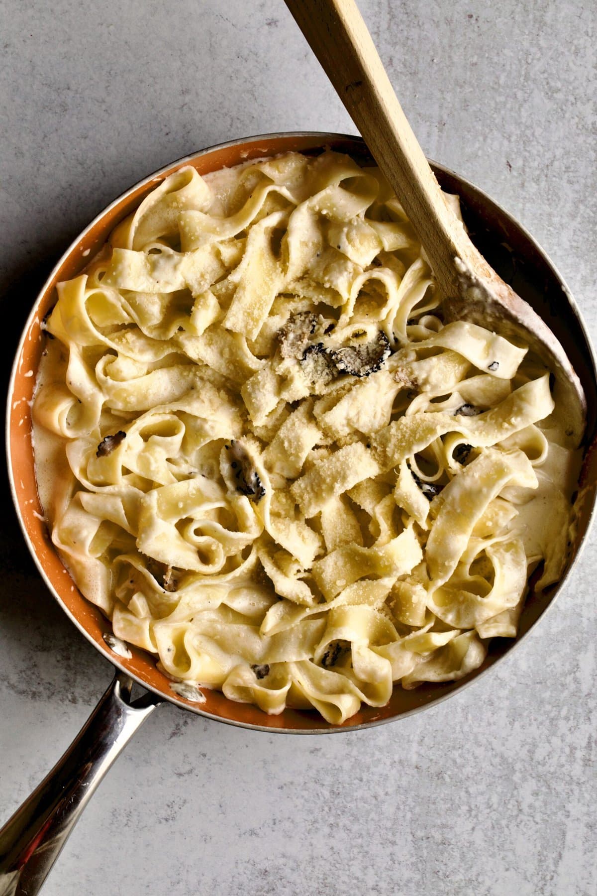 instructions for black truffle cream sauce: adding cooked pasta to prepared sauce.
