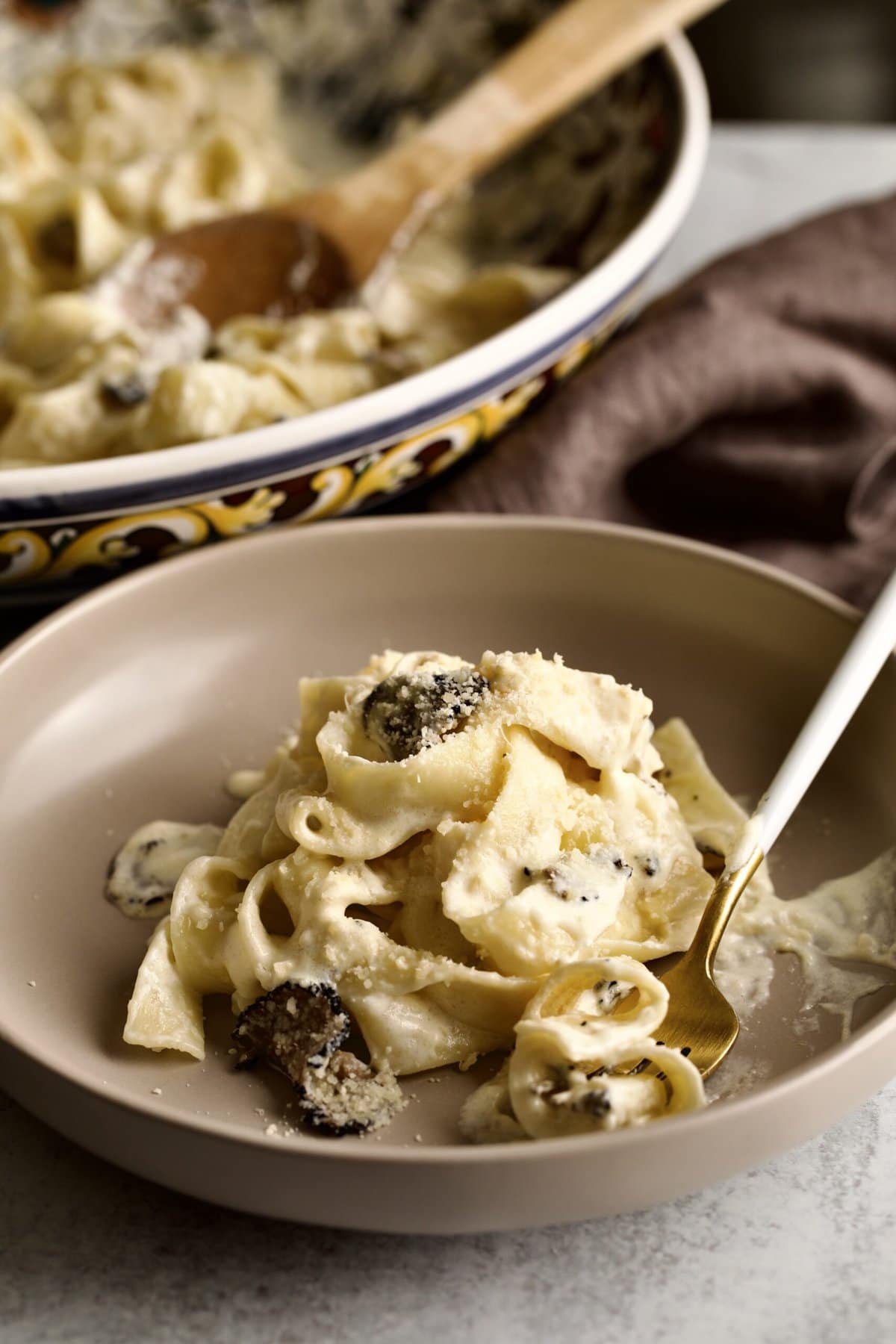 close up of platted pappardelle pasta with truffle cream sauce.
