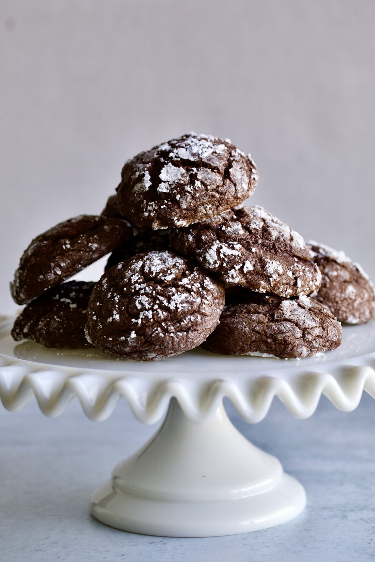 Chocolate spice cookies piled on a raised platter.